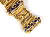 an image of a gold bracelet with blue and white stones