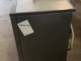 an image of a small refrigerator in a warehouse