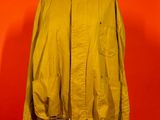 an image of a jacket on a mannequin stand against a red wall