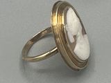 an image of a gold ring with a picture of a woman in a shell