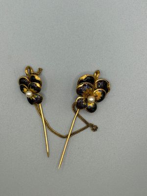 pair of black and gold flower hair pins with pearls