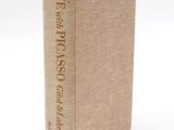 a book with a brown cover sitting on top of a white surface