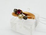 an image of a gold ring with a pearl and garnett