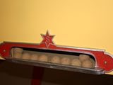 a close up of a red and silver object with a star on it