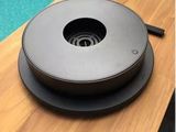 an image of a black round object on a wooden table