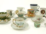 many cups and saucers that are sitting on a table