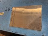 a metal plaque on the side of a blue box