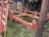 a red ladder leaning up against a pole in the grass