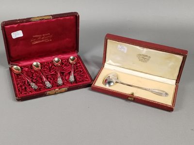 deux cuillères en métal argenté et un service d'argenterie dans un coffret rouge