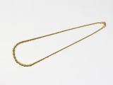 an image of a gold necklace on a white background