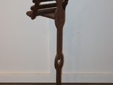 a wooden music stand in the corner of a room