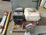a small engine sitting on a stand next to a fire hydrant