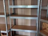 many shelves that have boxes on them in a room