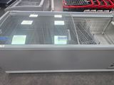 a display case in the middle of a store filled with food