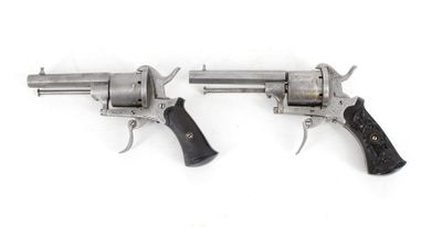 two revolvers are shown on a white surface with a white background
