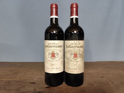 two bottles of wine sitting on a wooden table