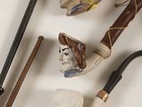 many different types of smoking pipes on the table