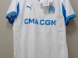 a white and blue shirt hanging on a wall next to a hanger
