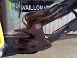 a close up of a machine that is parked in front of a building