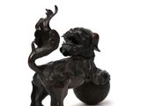chinese bronze figurine of a lion and a bird on a ball