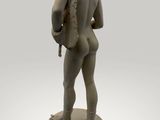 statue of a man standing on a pedestal with his back to the camera