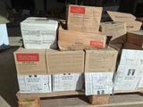 a pile of boxes sitting on a pallet in front of a building