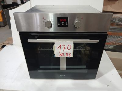 un four argenté posé sur une table blanche