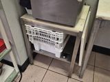 a sink and a laundry basket in a small room