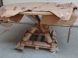 a table made out of cardboard sitting on top of a pallet