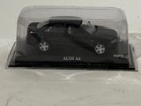 a black toy car in a clear case on a white surface