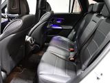 the interior of a car with black leather seats and a blue light