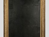 an antique gold framed mirror with a black background