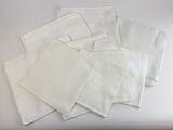 several white napkins on a white table with a white background