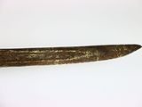a very long piece of metal on a white surface