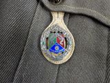 a badge on the back of a man ' s jacket
