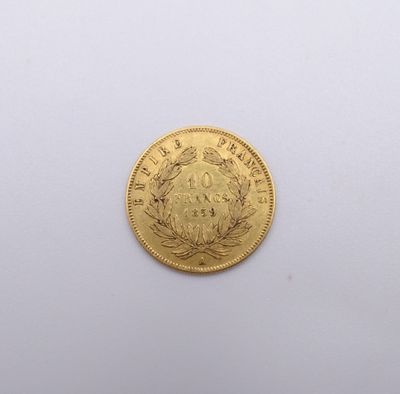 a close up of a gold coin on a white surface