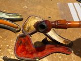 a lot of different types of smoking pipes on the table