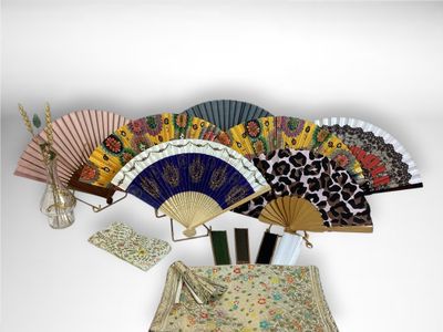 many different types of hand fans on a table