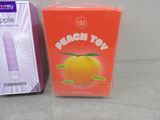 a box of peach toy next to a box of oranges