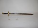 an old sword with a wooden handle on a clear stand
