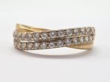 a close up of a gold ring with two rows of diamonds