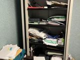 a closet full of clutter in the corner of a room