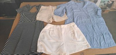 three pieces of clothing sitting on a table in front of a window