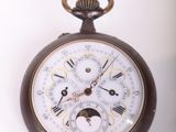 a brown pocket watch with roman numerals on the face