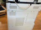 a white printer sitting on top of a wooden floor