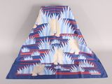 a blue and red blanket with a white dog on it