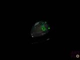 an oplite in the dark with a green glow