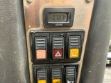 a close up of a control panel with a clock on it