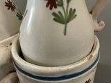 two vases with flowers painted on them stacked on top of each other