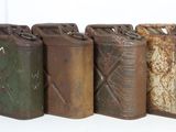 several old metal cans are lined up in a row